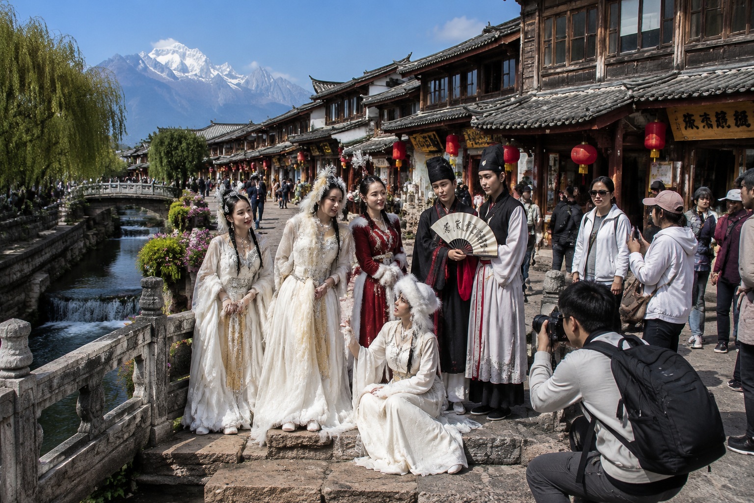 Tourists in rented Tibetan and Han dynasty costumes take photos on a stone bridge in Lijiang Old Town, a canal below and a snow mountain behind.