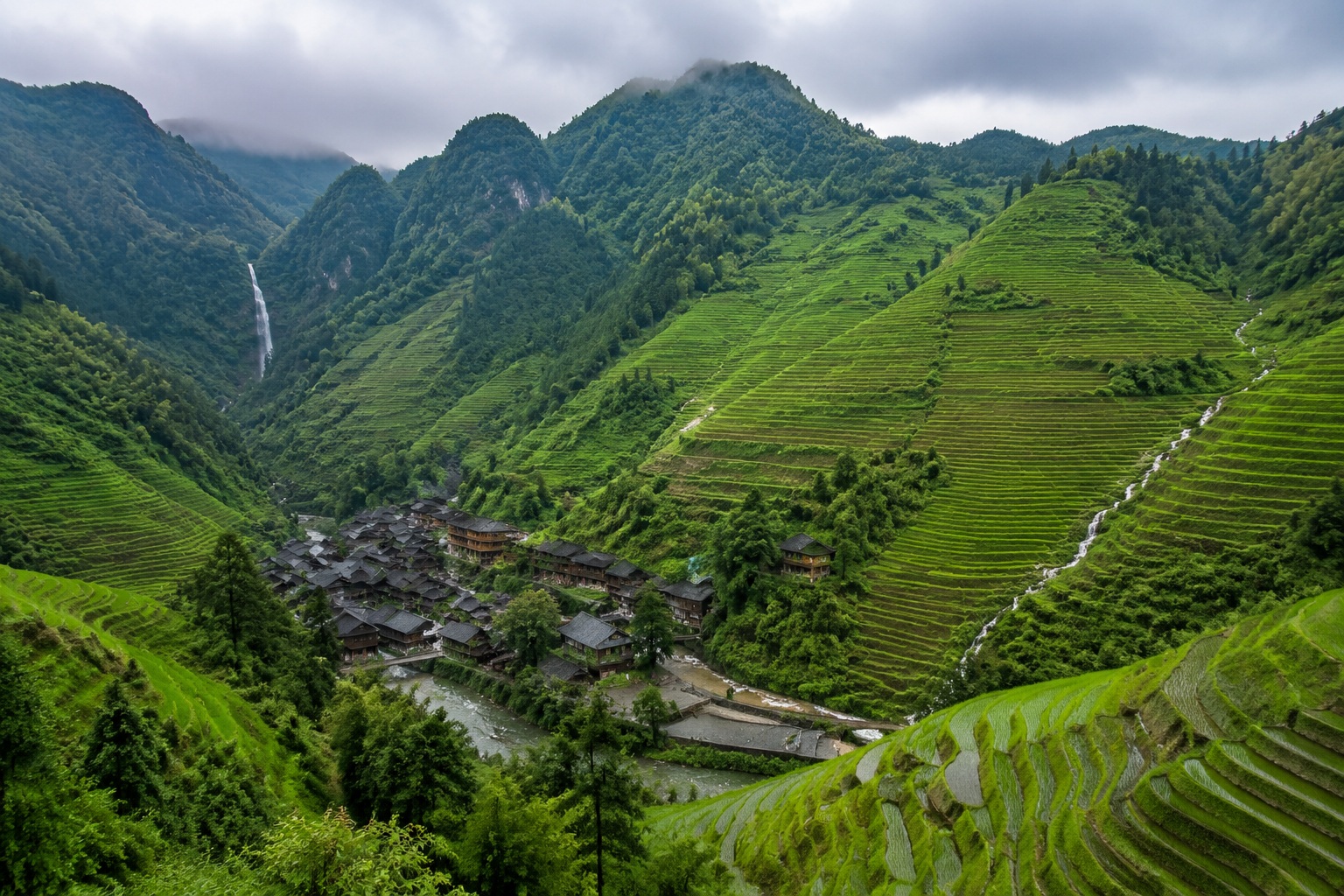 Rice terraces and a small hidden waterfall above the village behind Xiaoqikong, Guizhou.
