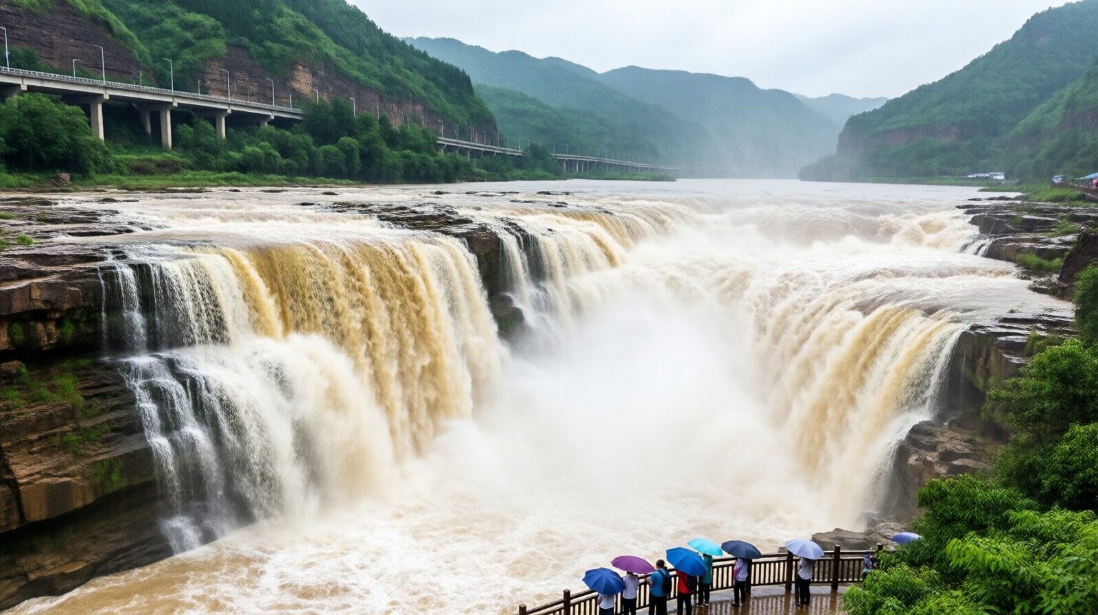 Huangguoshu Waterfall in Guizhou with a distant highway bridge