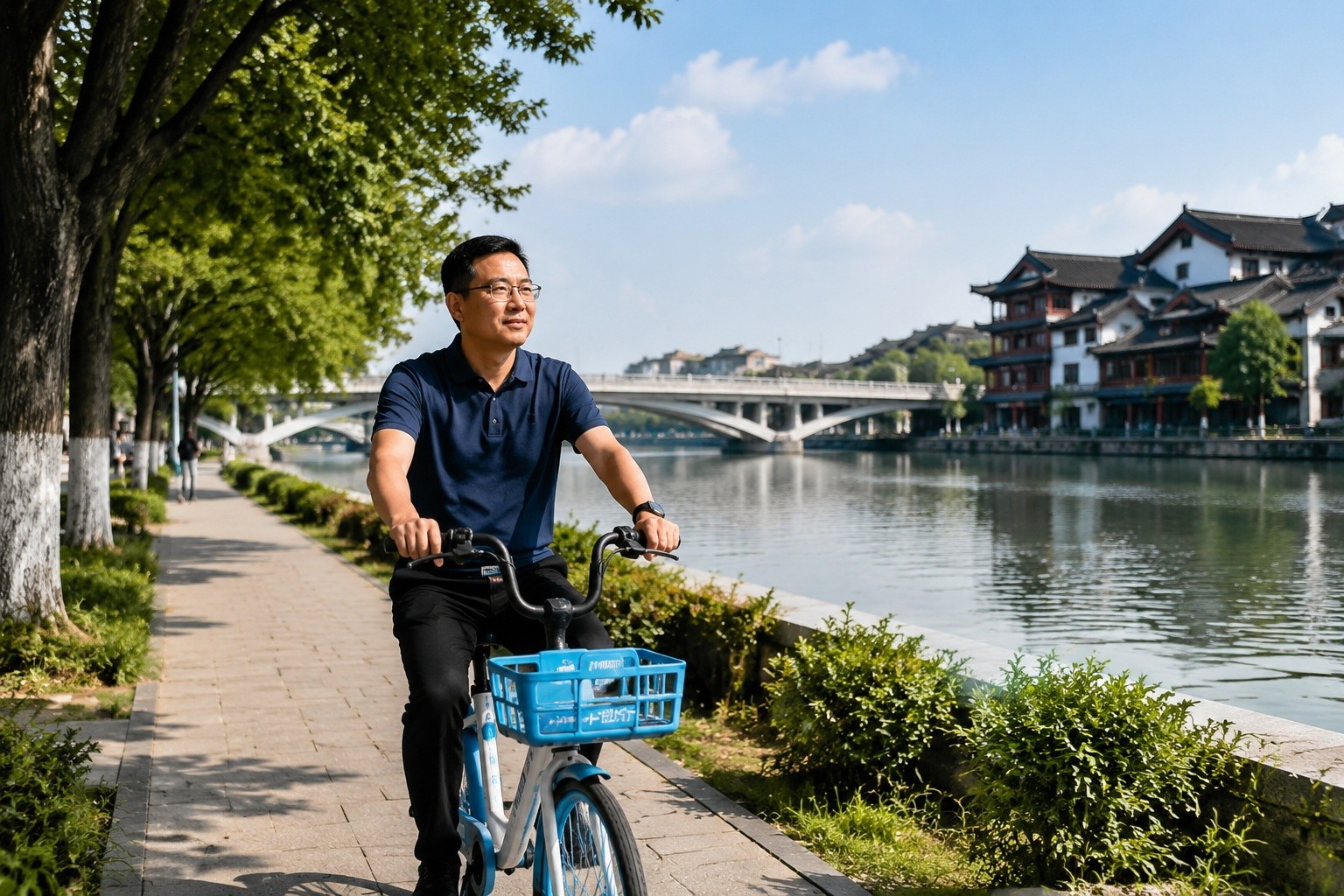 A man cycling on a greenway beside the Grand Canal in Hangzhou, with historic buildings and a modern bridge visible.