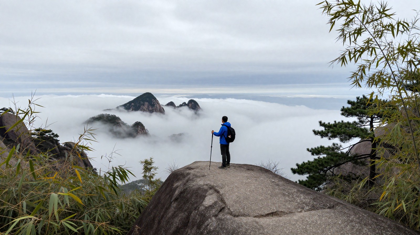 Hiker on a ridge at Qiyun Mountain overlooking a vast sea of clouds and distant peaks.