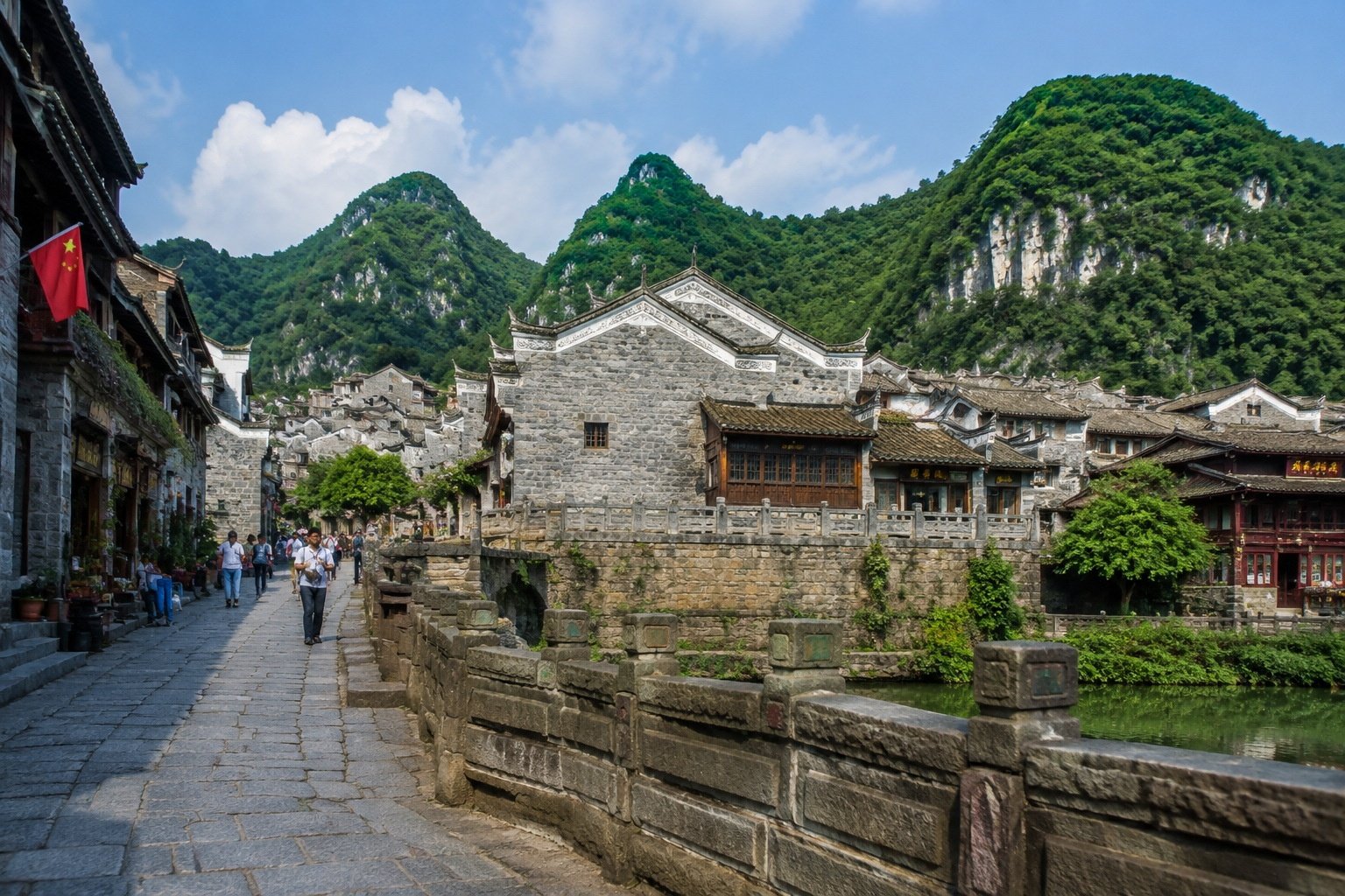 Tourists exploring Qingyan ancient town on a pleasant summer day near Guiyang, China