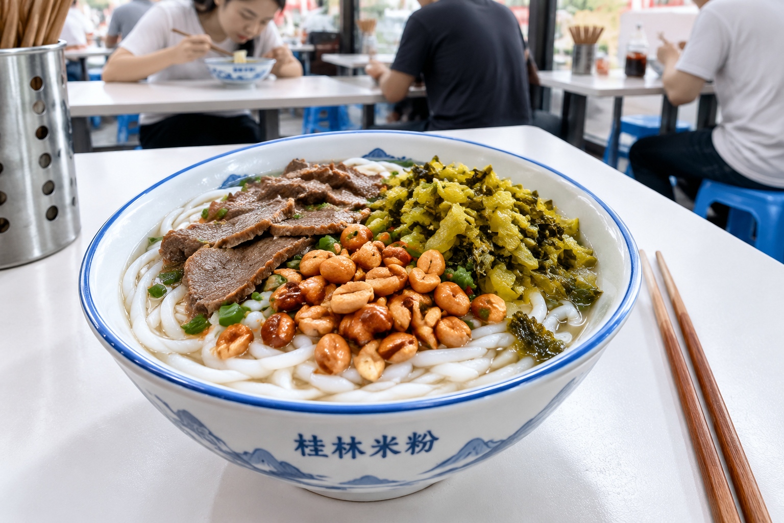 A close-up view of a bowl of Guilin rice noodles with toppings like peanuts, meat, and pickled vegetables on a plastic table