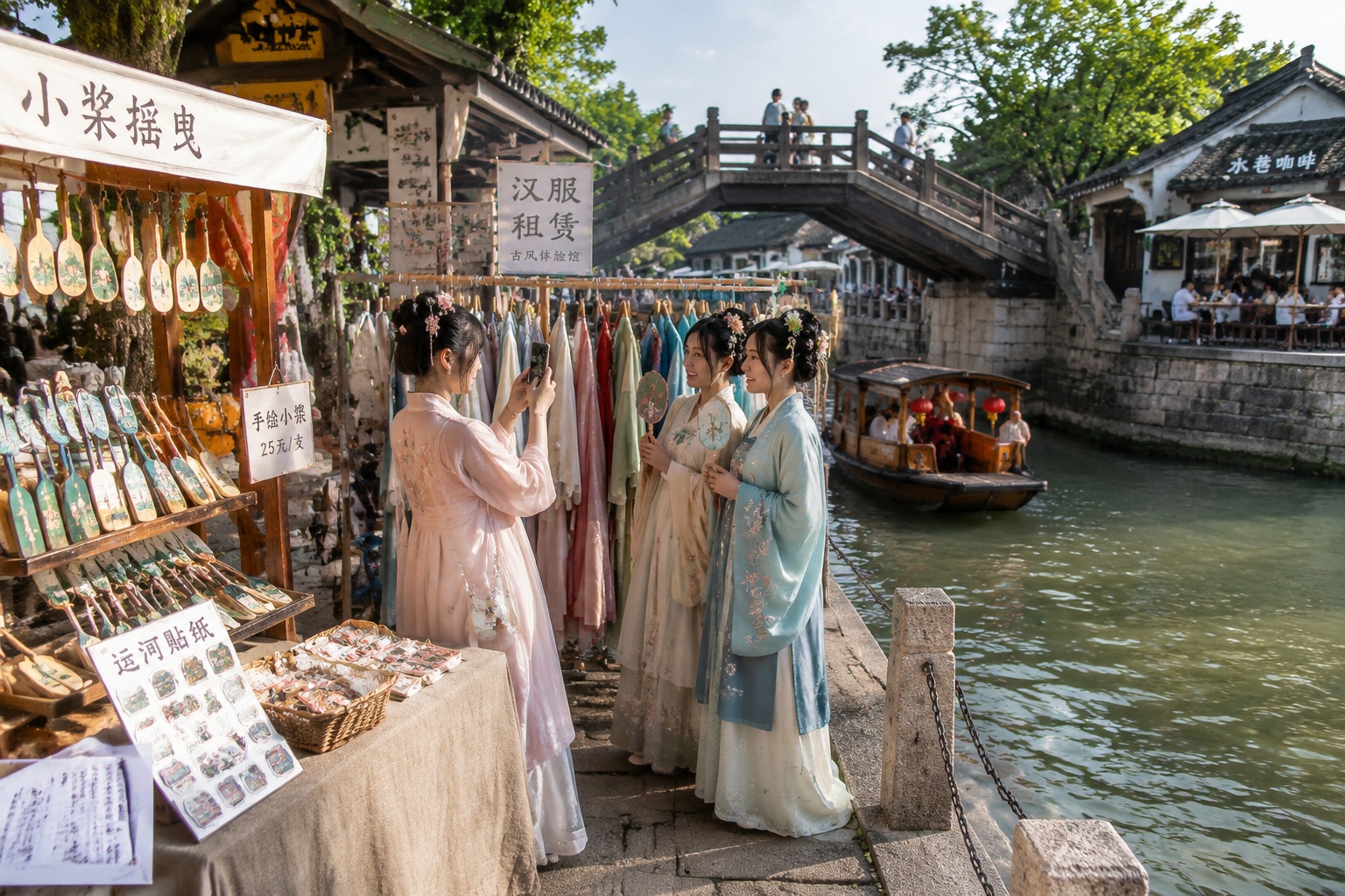 Weekend canal market in a Chinese town with young women in Hanfu taking smartphone photos beside a wooden bridge, stalls with canal souvenirs, and a cafe by the water.