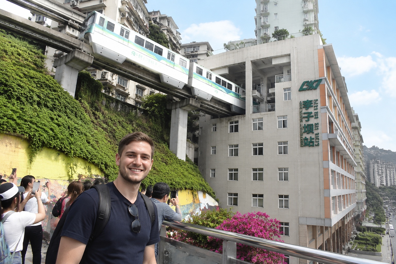 Chongqing Light Rail Line 2 monorail passing through the Liziba residential building, with tourists watching from the observation deck.