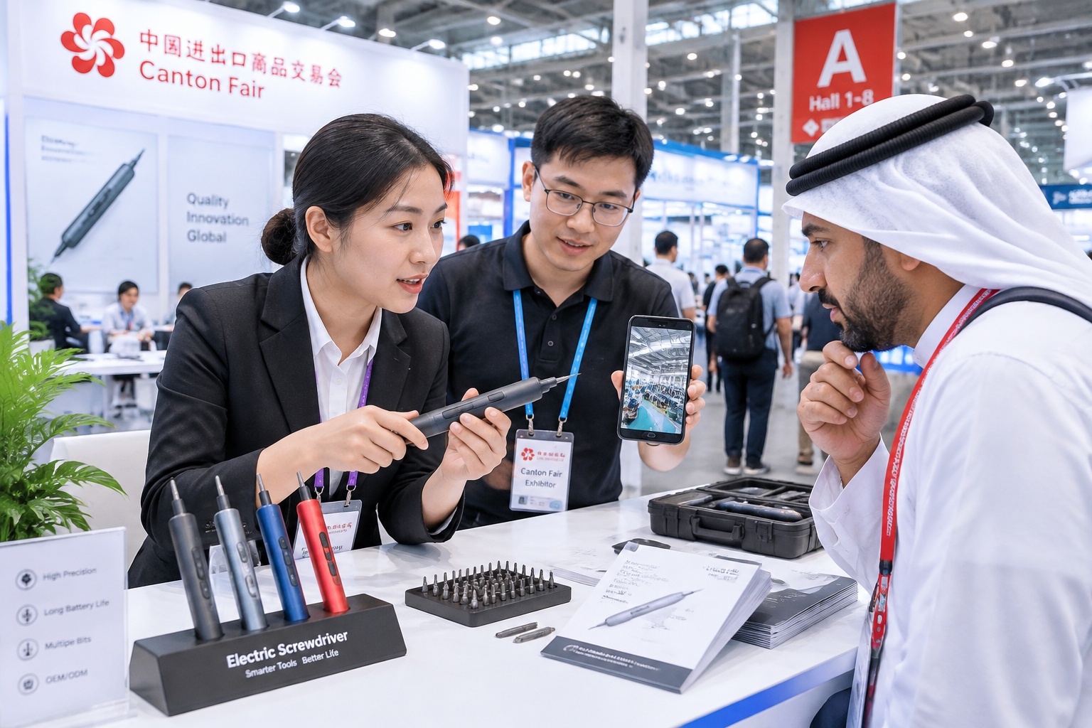 Sales representative demonstrating a power tool to an international buyer inside Canton Fair Hall A