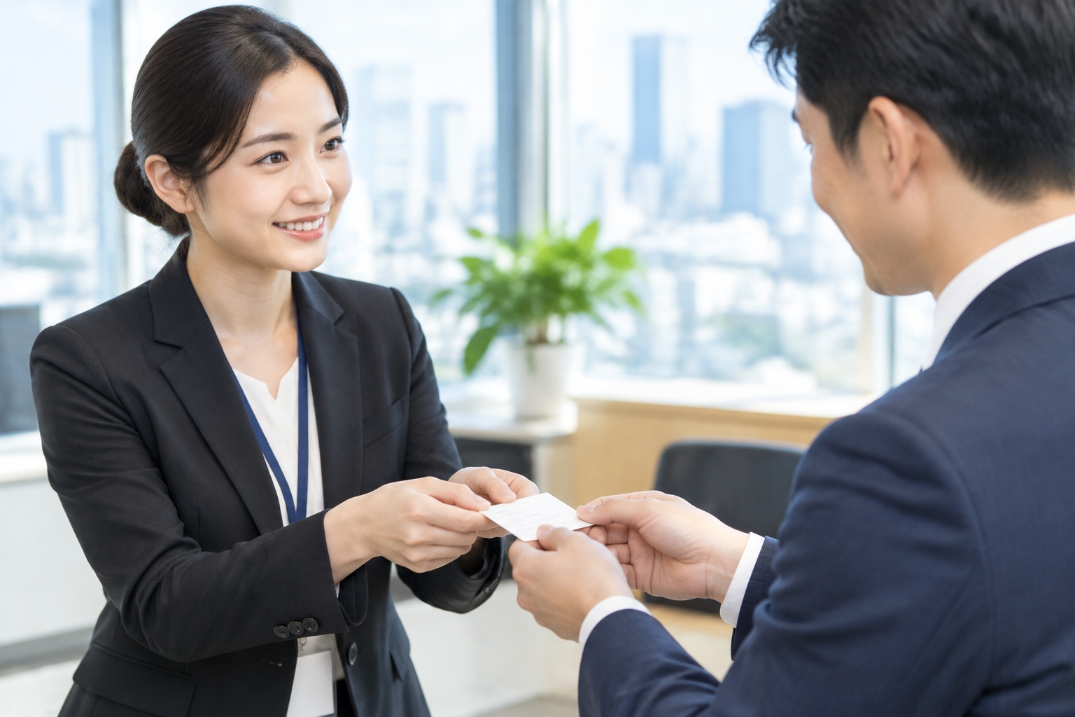 Chinese business person exchanging name card with both hands with a foreign counterpart
