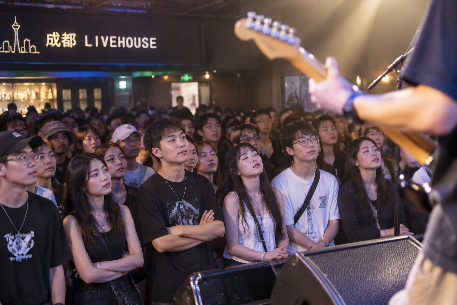 Audience at a Chengdu indie rock concert, eyes closed, lost in the music