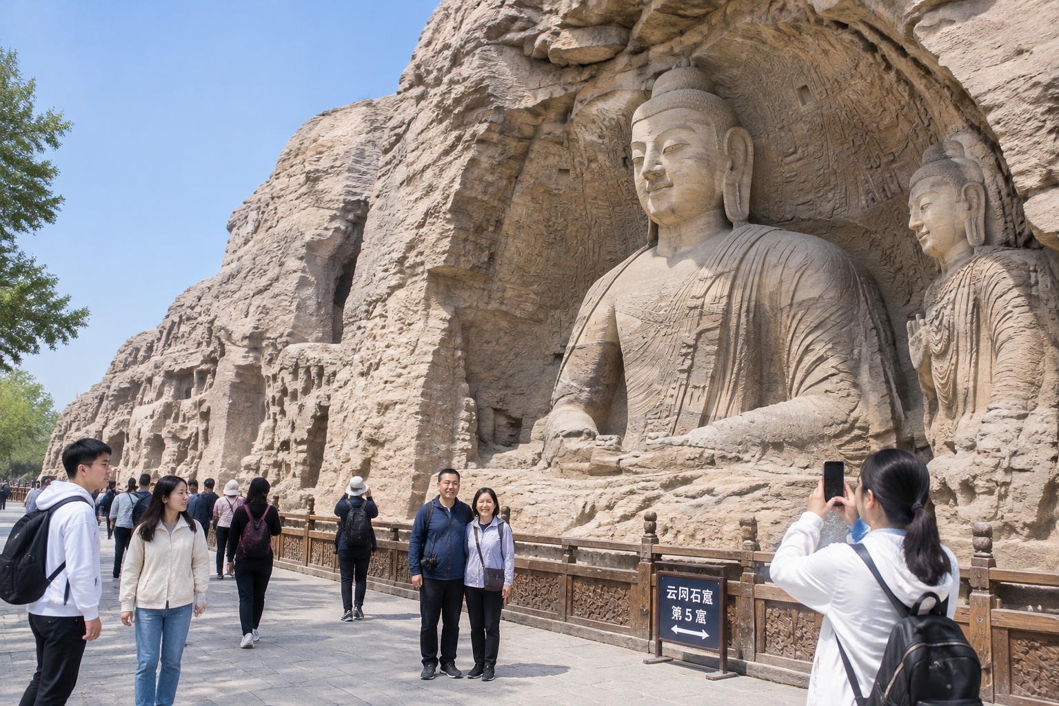 Tourists walk past the giant carved Buddha statues at the Yungang Grottoes near Datong, one of Shanxi's most visited attractions.