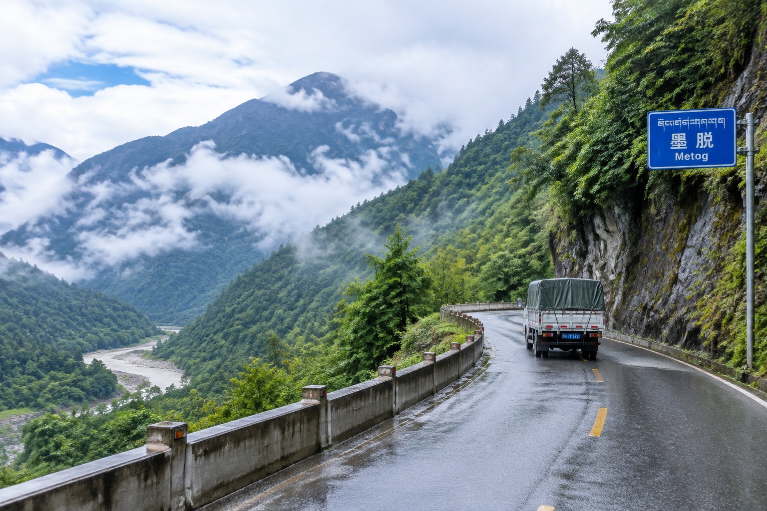 Zhamo Road winding through steep green mountains in Metog, Tibet, with a small truck driving on the asphalt