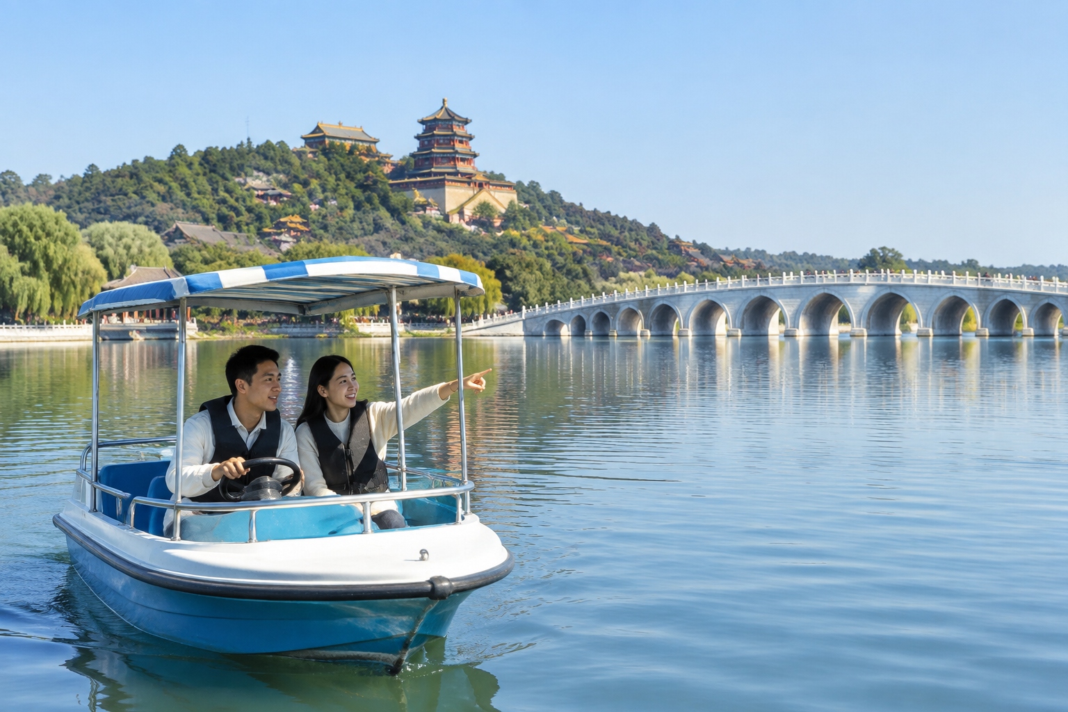 Two visitors steer a small electric boat on Kunming Lake in the Summer Palace, Beijing, with the Seventeen-Arch Bridge and Longevity Hill in the background under a clear morning sky.
