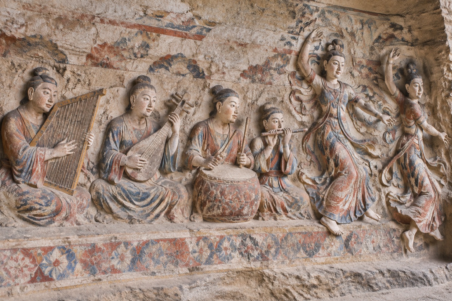 Carvings of musicians and dancers in Cave 12 at the Yungang Grottoes, including a Persian-style angular harp and a pipa lute