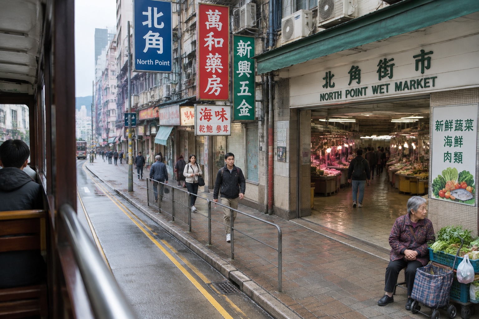 View from the upper deck of a Hong Kong tram passing through North Point with street signs and pedestrians