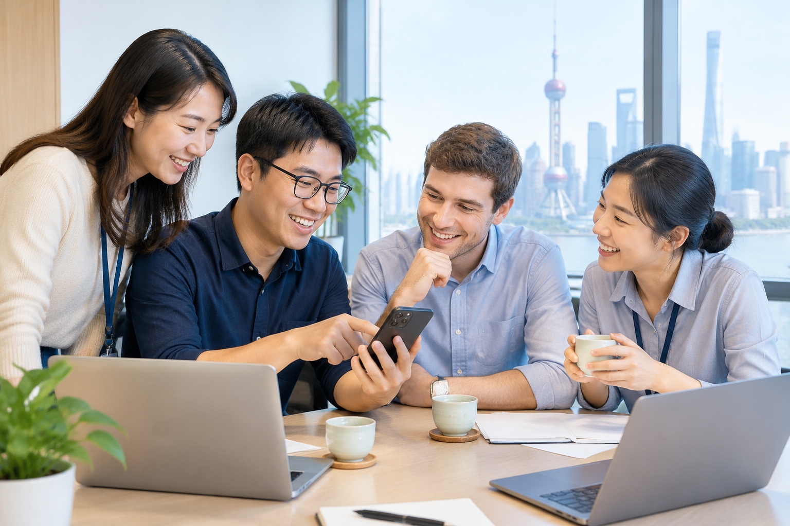 How Chinese Netizens Name Foreigners: The Legend of Nicholas Cuihua 23 Chinese coworkers laugh with a young foreign colleague looking at a smartphone in a Shanghai office